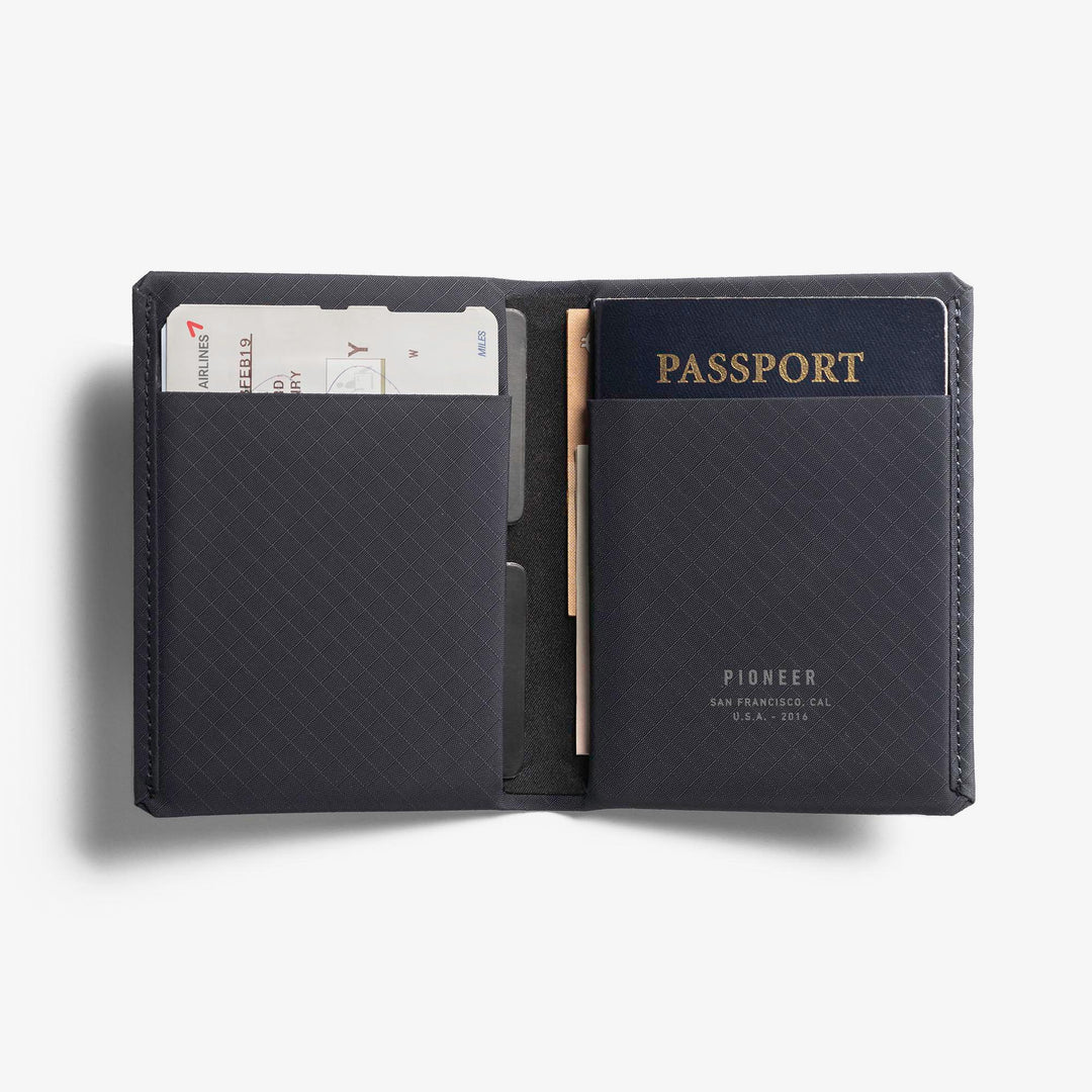 Pioneer Carry Passport Wallet Navy Color with Vaccine Card open on table #color_navy-3xd