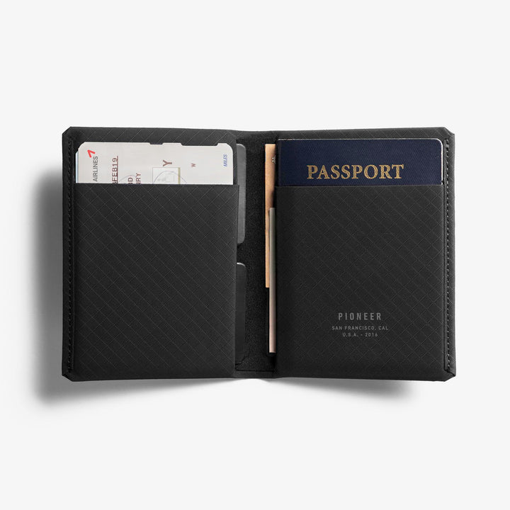 Pioneer Carry Passport Wallet Onyx Color with Vaccine Card open on table  #color_onyx-10xd